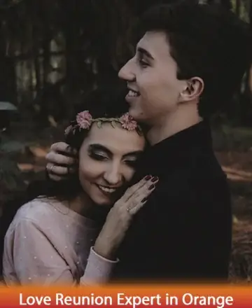 In the gentle embrace of nature’s serene backdrop, a couple finds solace and warmth in each other's arms. Their peaceful smiles speak of a deep, unspoken connection, blooming like the delicate flowers in her hair. Love reunion expert in Orange.