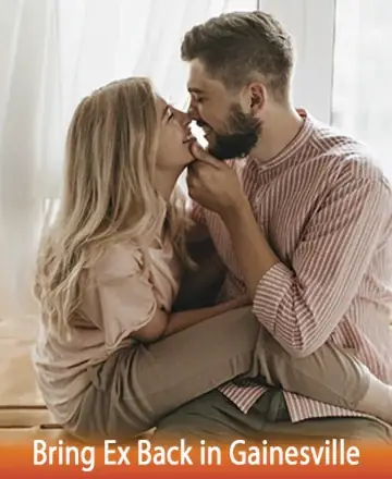 A young couple sitting closely and gazing into each other's eyes while smiling, suggesting a rekindled relationship. The cozy indoor setting features a window with soft curtains. Both are casually dressed; the woman in a light pink top and the man in a pink striped shirt. The text on the image reads 
