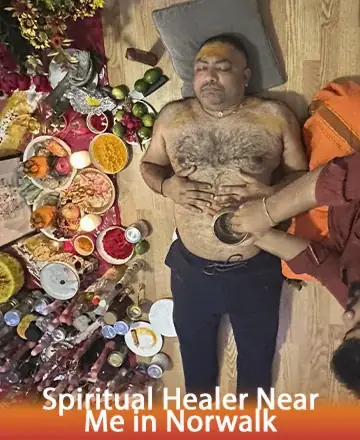 In a serene setting adorned with vibrant offerings, a calm soul receives gentle, healing energy. The warm touch and soothing atmosphere invite peace and tranquility, nurturing the spirit with care and wisdom. Spiritual healer near me in Norwalk.