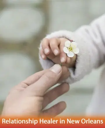 In a gentle exchange, a small hand offers a delicate flower, symbolizing the pure and tender connections we nurture. This peaceful moment reflects the warmth and care we seek in our relationships, guiding us towards harmony and understanding. Relationship healer in New Orleans.