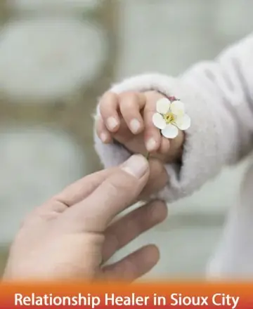 In the gentle exchange of a delicate flower, a profound connection blossoms, symbolizing trust and the tender bond between souls. This serene moment offers a glimpse into the beauty of shared understanding and compassion. Relationship healer in Sioux City.