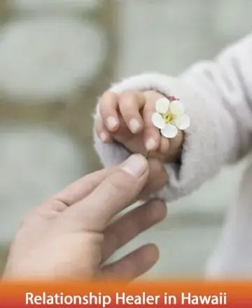 In a tender moment, a small hand offers a delicate blossom, symbolizing the gentle exchange of love and care. This serene gesture invites a sense of peace and connection, nurturing the spirit with warmth and understanding. Relationship healer in Hawaii.