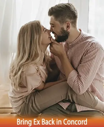 A couple sitting closely and affectionately, smiling at each other. The woman, with long blonde hair, wears a light pink blouse and khaki pants, while the man, with a beard, is dressed in a pink and white striped shirt and beige pants. Text at the bottom reads 