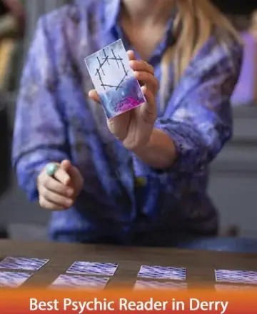 In a serene setting, a gentle hand reveals a tarot card, inviting reflection and insight. The soothing hues and calm atmosphere create a space of trust and understanding, where guidance flows naturally. Discover the path to inner peace with the best psychic reader in Derry.