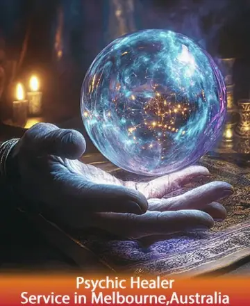 In a serene atmosphere, a gentle hand cradles a luminous crystal ball, casting a soft glow that whispers of ancient wisdom and inner peace. The warm candlelight adds a comforting embrace, inviting calm reflection. Psychic healer in Melbourne, Australia.