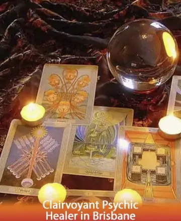 In a serene setting of gentle candlelight, tarot cards unveil their wisdom alongside a radiant crystal ball. This tranquil scene invites you to explore hidden depths and embrace guidance with an open heart. Discover peace and clarity with a clairvoyant psychic healer in Brisbane.